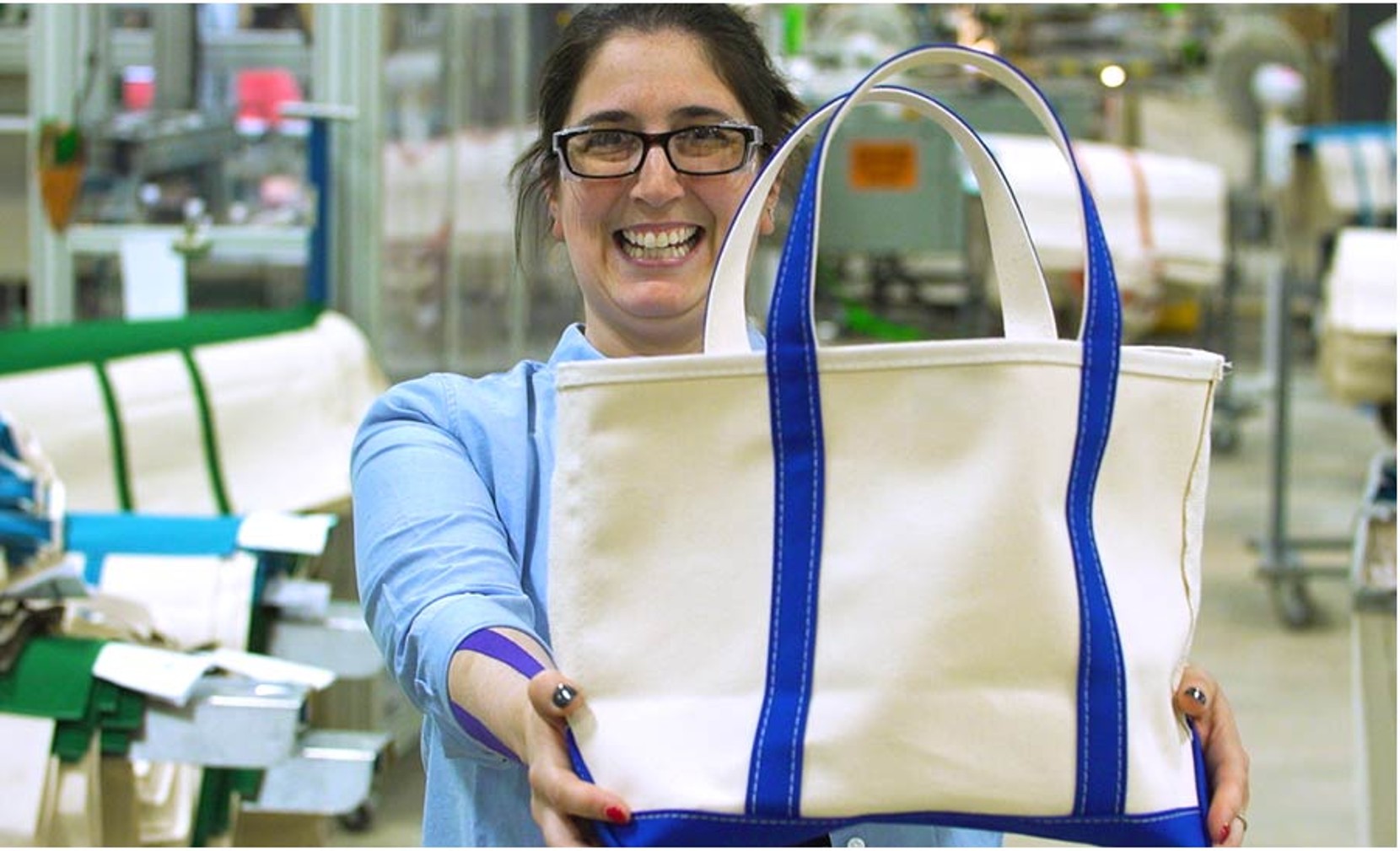 Woman holding an L.L.Bean tote. 