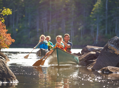 People in two canoes paddling on a lake