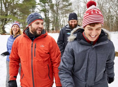 Group of 4 people dressed in L. L. Bean outerwear and winter hats.