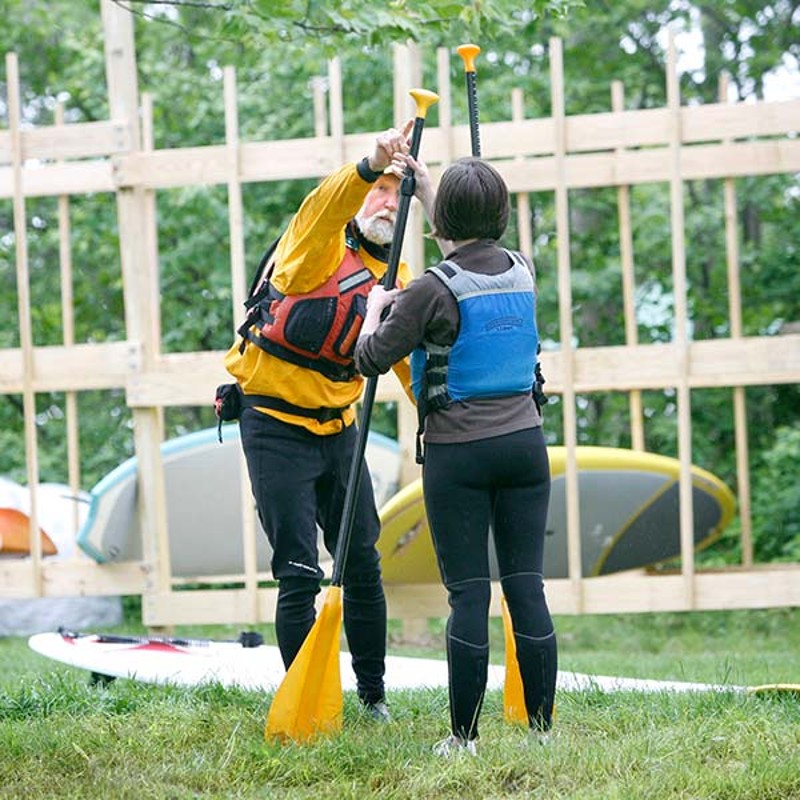 L.L.Bean Guide showing customer how to hold Stand up Paddle Board Oar