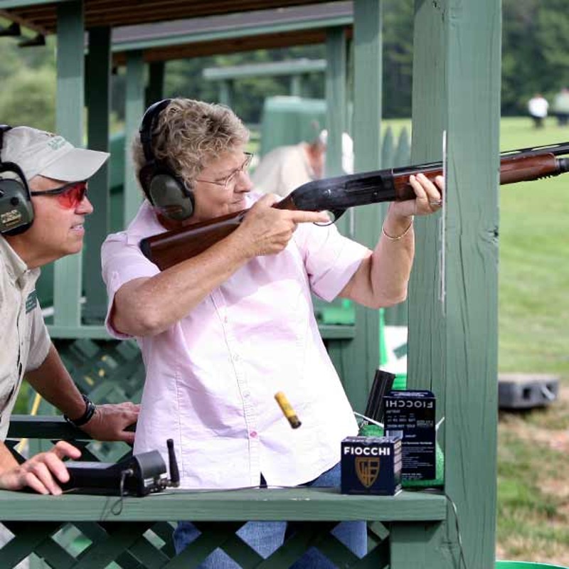 People trap shooting.