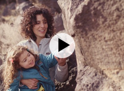 Child and mom looking at a petroglyph.