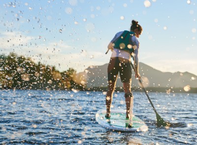 Woman paddling on a stand up paddleboard.