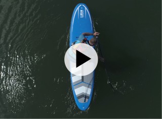 An overhead shot of a man paddling a SUP, a play video symbolin the center.