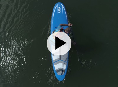 An overhead shot of a man paddling a SUP, a play video symbolin the center.