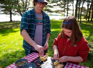 Father and daughter making a camp meal