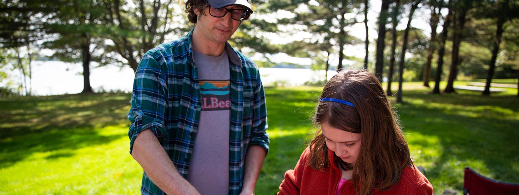 Father and daughter making a camp meal