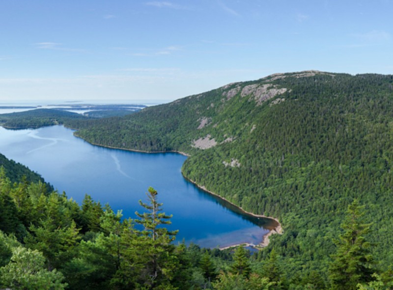 Beautiful view from above of a mountain and body of water on a clear day.