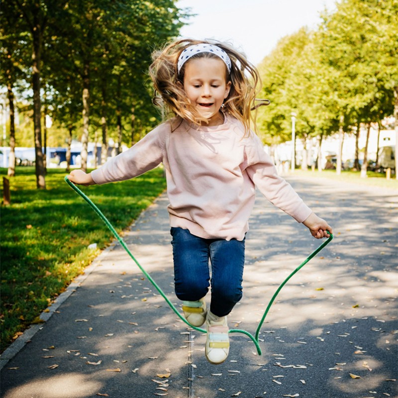 A young girl jumping rope.