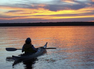 kayaker on the water at sunset