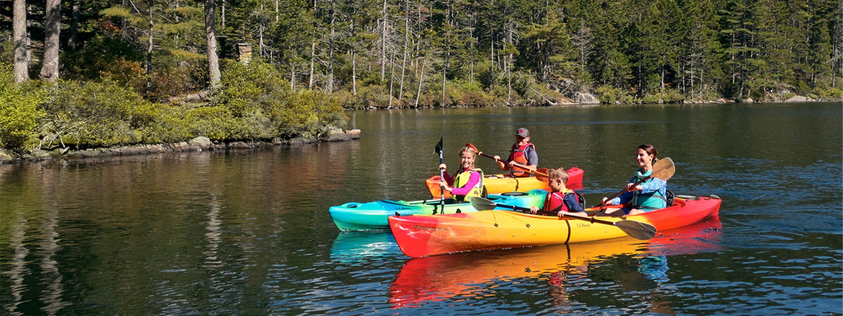 A family kayaking on a lake.