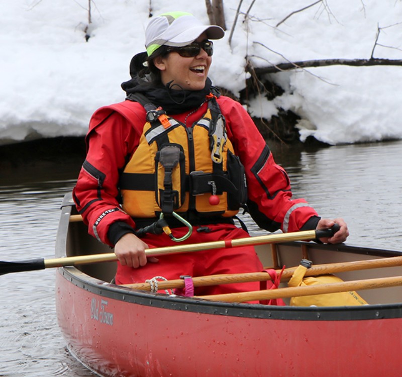 Susan Quaintance paddling a canoe in winter