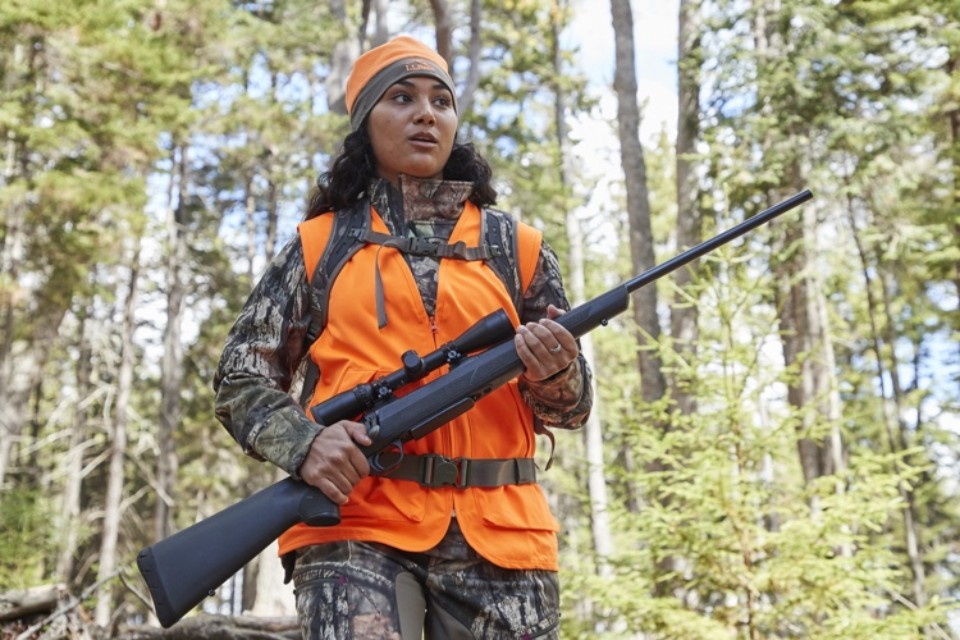 Desiree Vargas in the woods hunting.