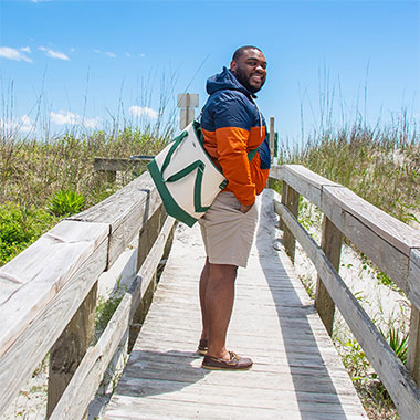 Man on a beach boardwalk.