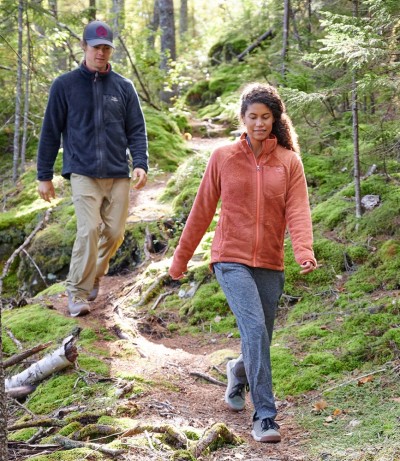 Two people walking through the woods