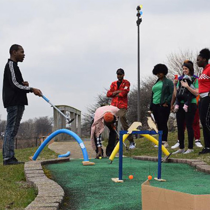 People playing miniature golf.