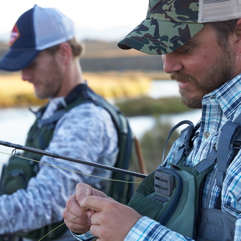 Close-up of two men holding fishing rods