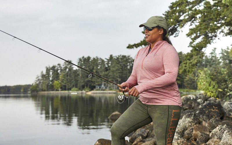 A woman in L.L.Bean gear fishing.