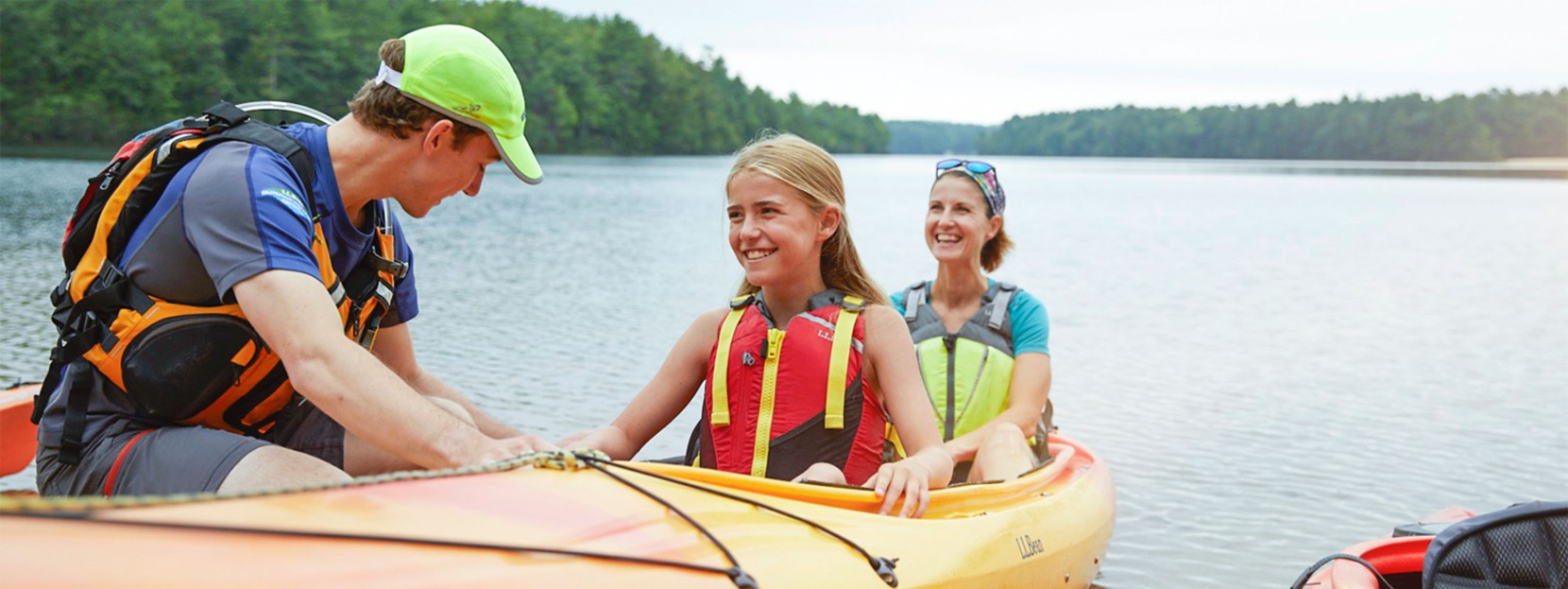 A mother and daughter learning how to launch a kayak.