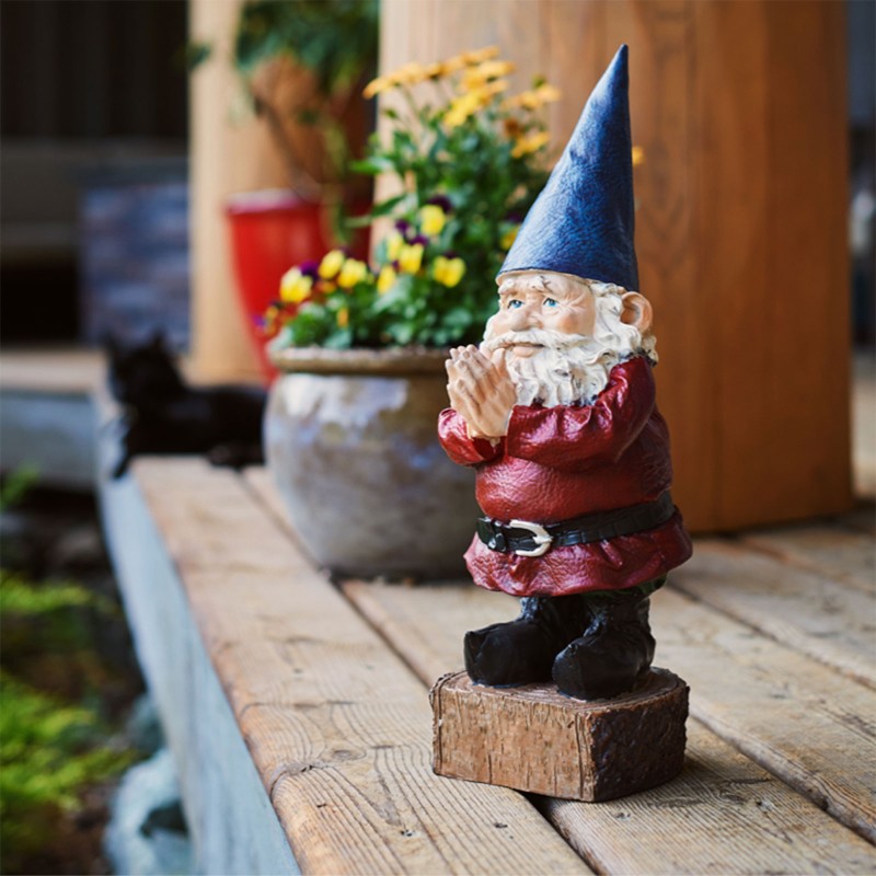 A wooden gnome figure on a porch step.