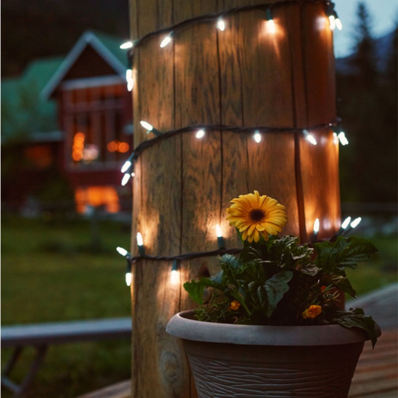 White string lights wrapped around a porch column.