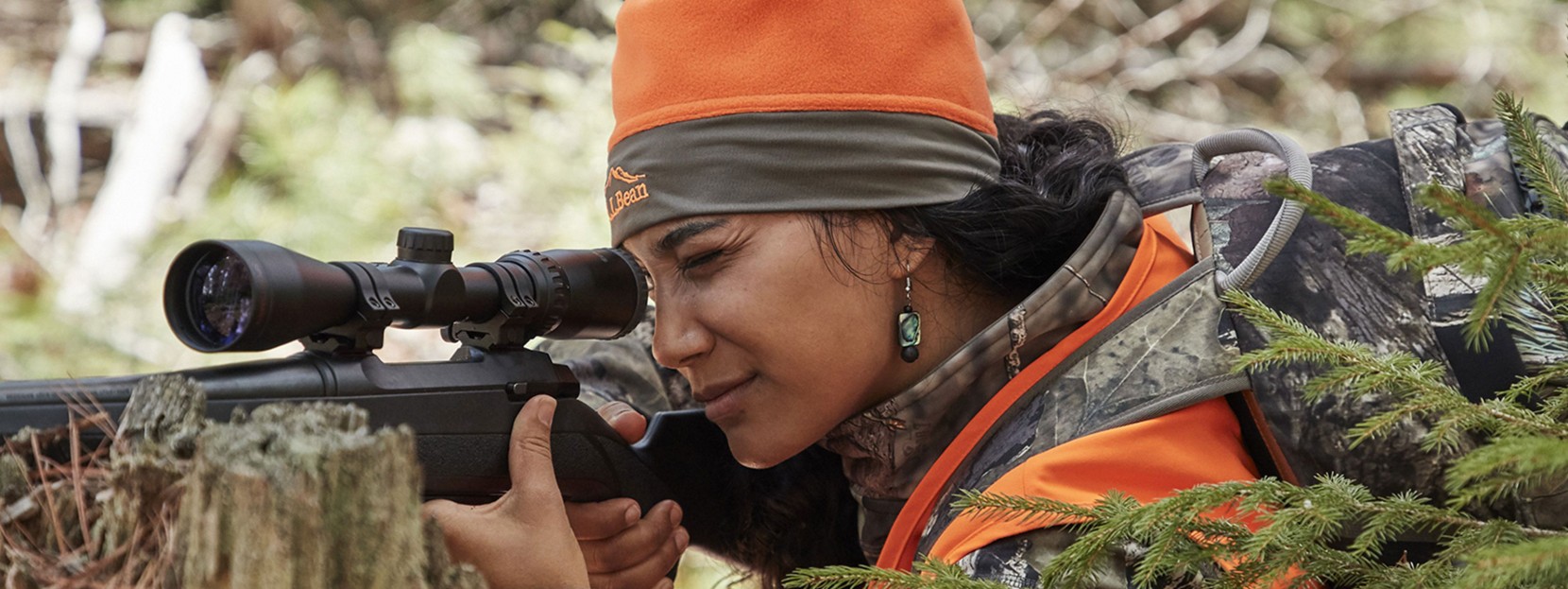 A hunter looking through the scope of the gun.