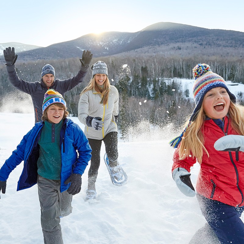 Happy family running in the snow