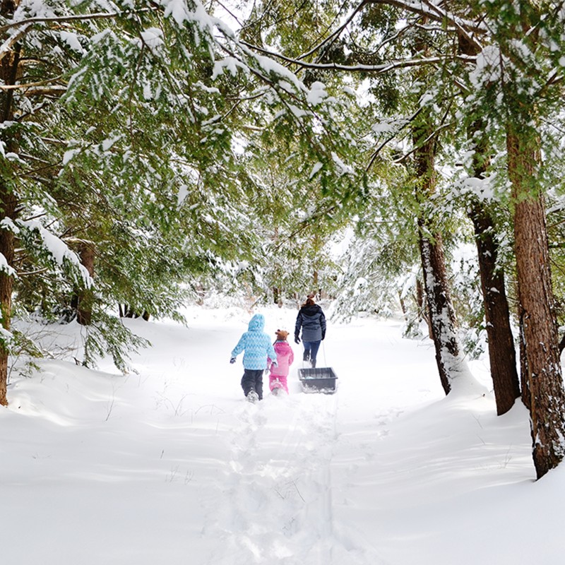 People in the distance walking down a snowy trail