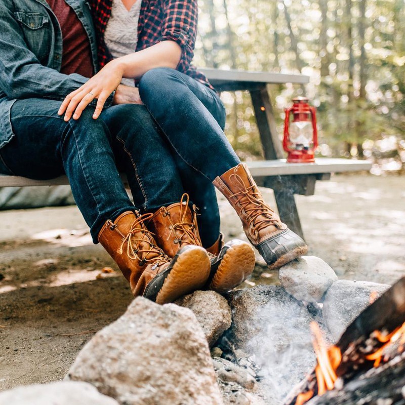 A couple in L.L.Bean Boots by the campfire