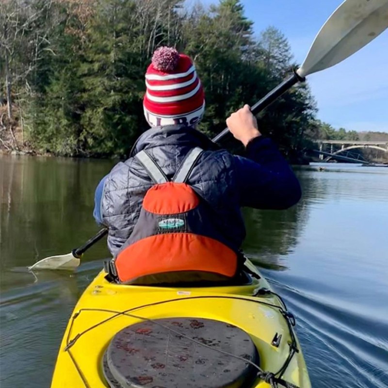 Dan Tarkinson shot from behind, paddling a kayak.