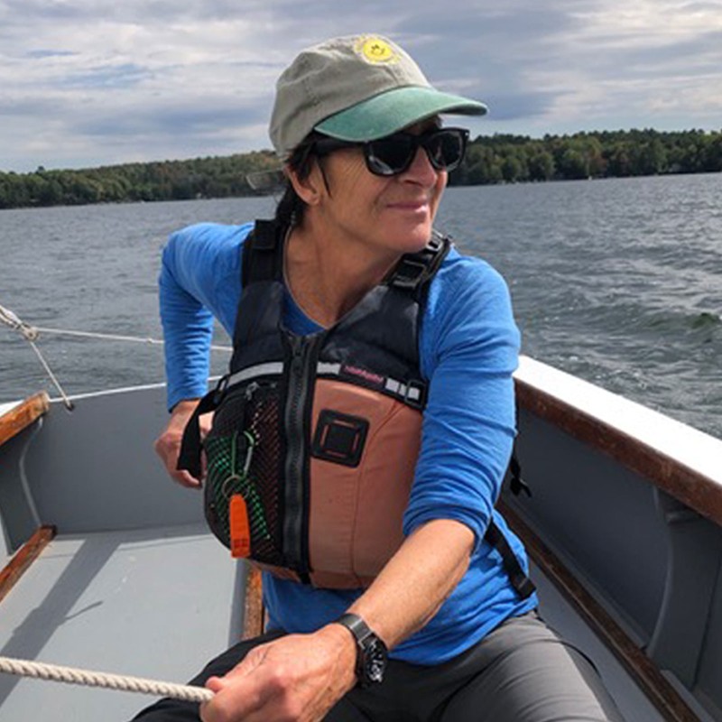 Mary M-B, at the tiller of a small sailboat.