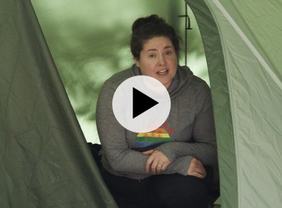 Woman in a tent looking at the camera, text How to Break Down a Tent and L.L.Bean logo.
