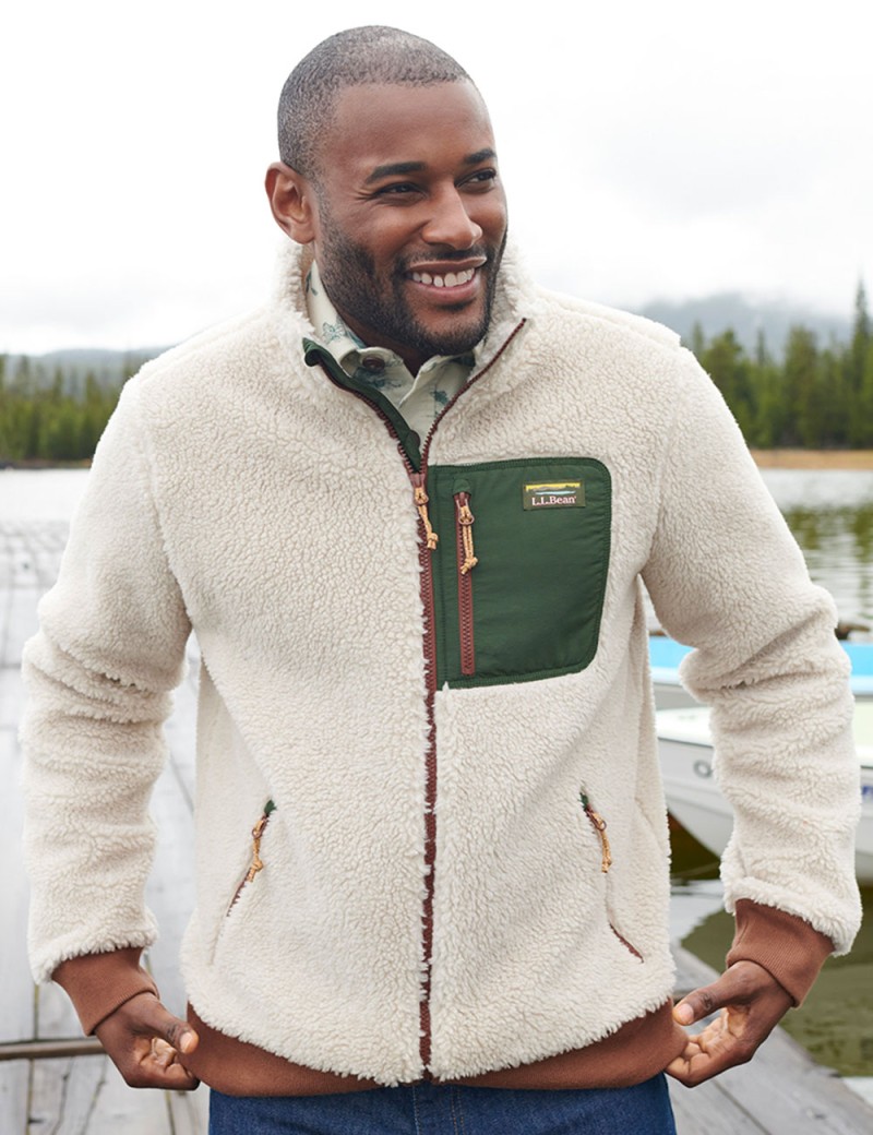 Smiling man outside wearing a fleece jacket.