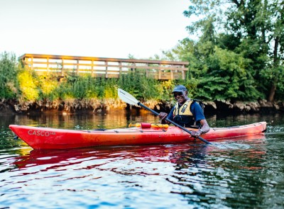 Forrest Mayo paddling in a red kayak.