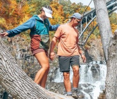 couple hiking near waterfall
