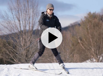 L.L.Bean Outdoor Discovery Programs instructor demonstrating downhill technique on cross-country skis.