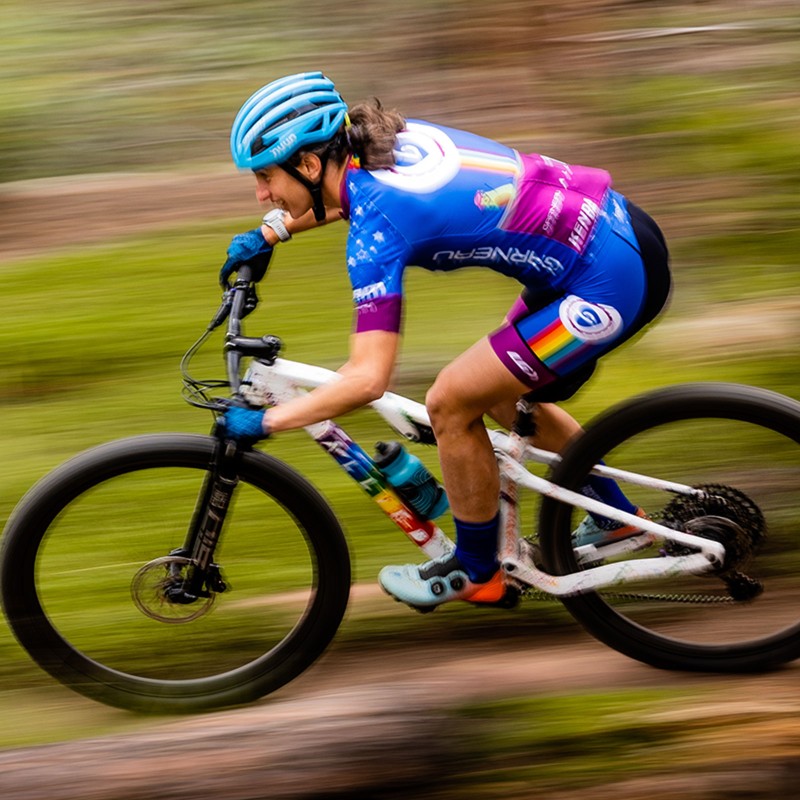 L.l.Bean Ambassador Lea Davison riding fast on a mountain bike.