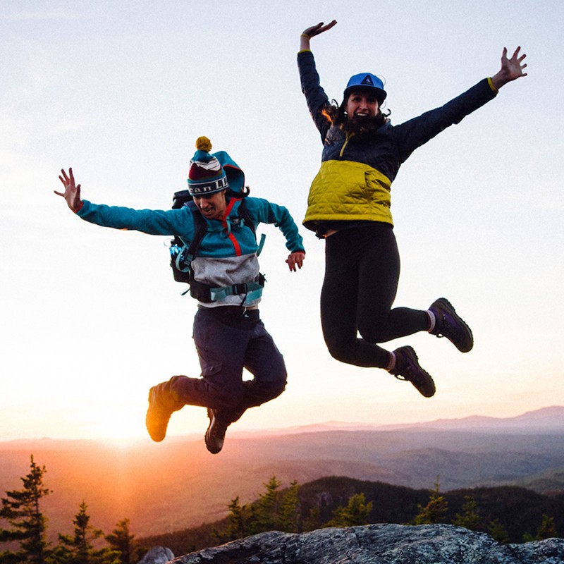 Lea Davison and friend jumping in the air.