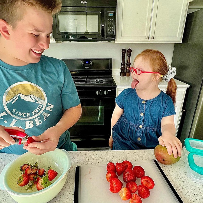 Melody's son and daughter in the kitchen preparing fruit.