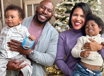 The Brooks family standing in front of their holiday tree.