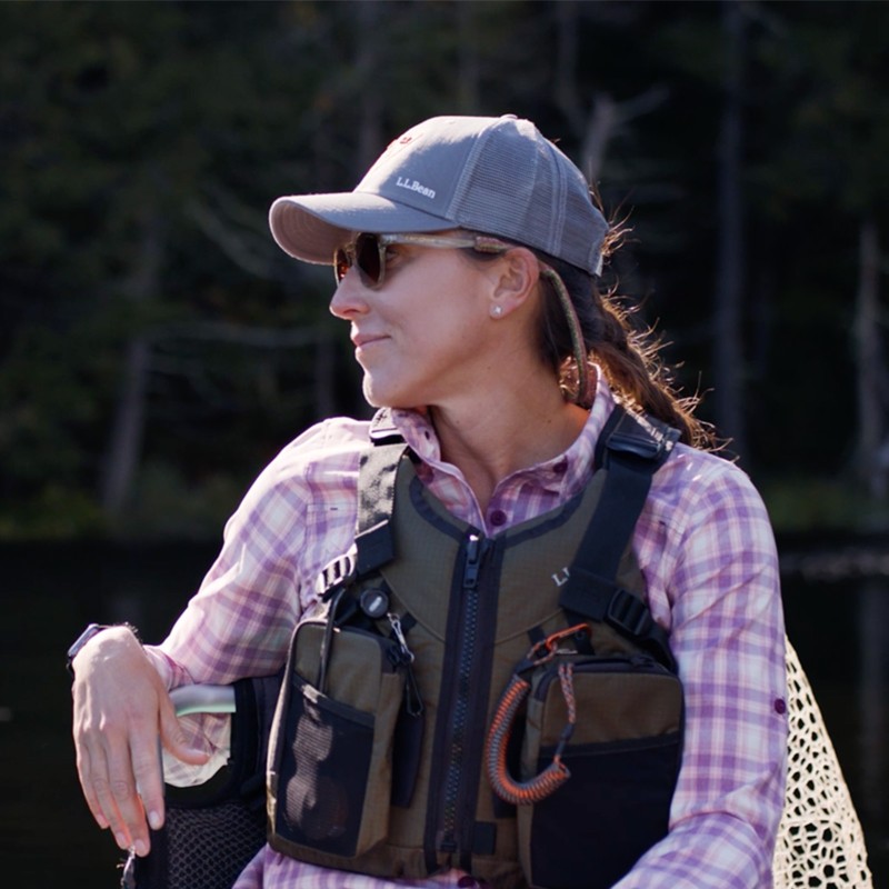 A woman wearing a fishing vest.