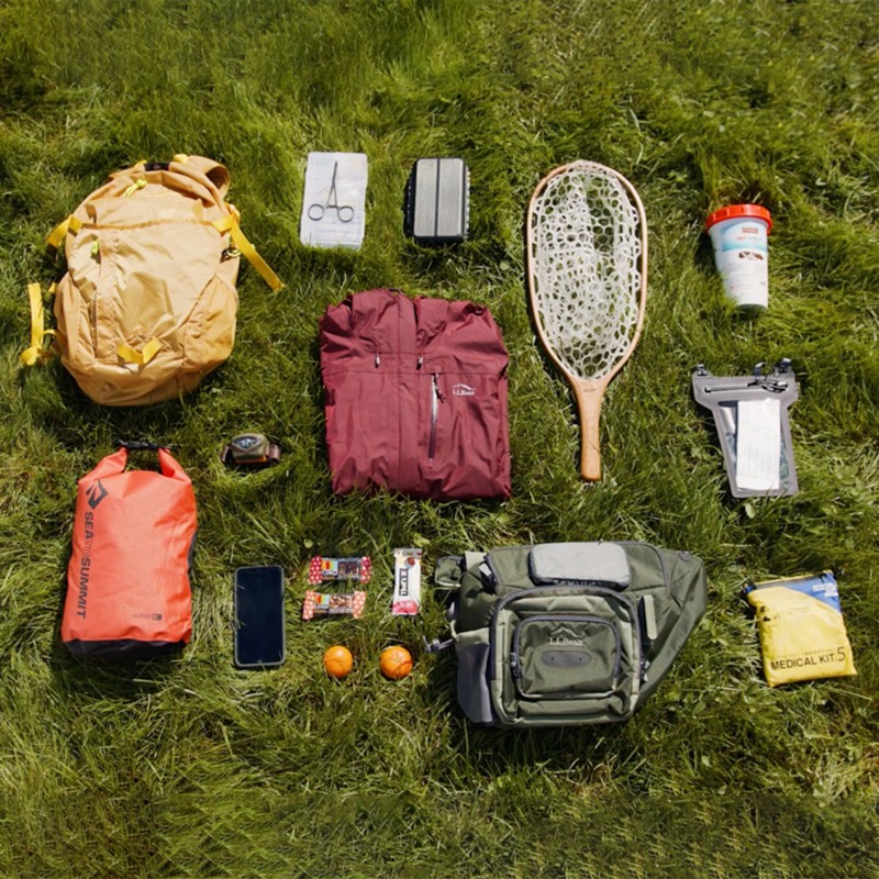 Fishing gear laid out on the grass.