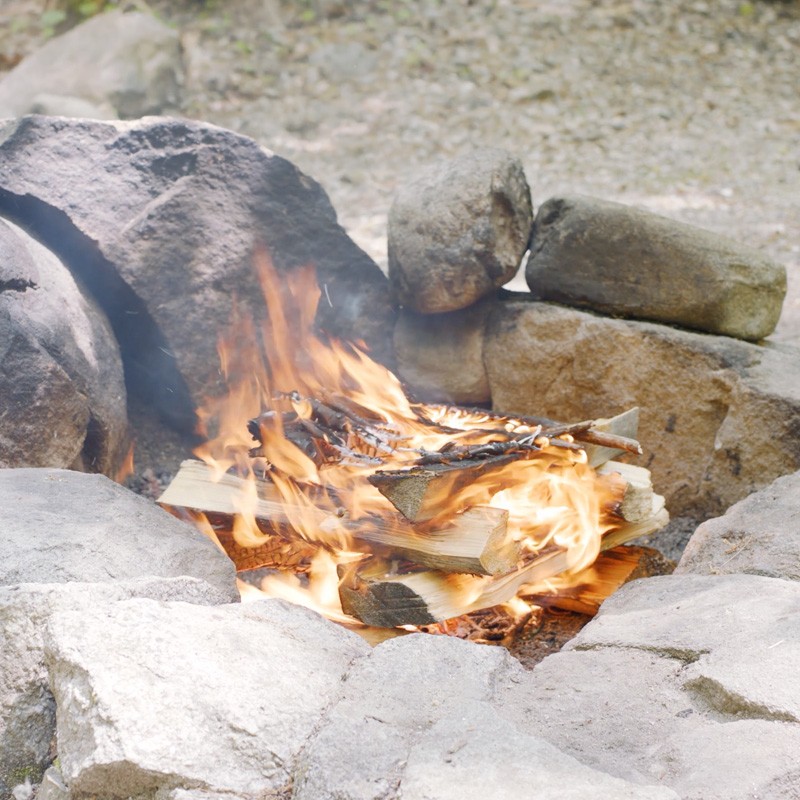 A roaring fire in a fire ring.