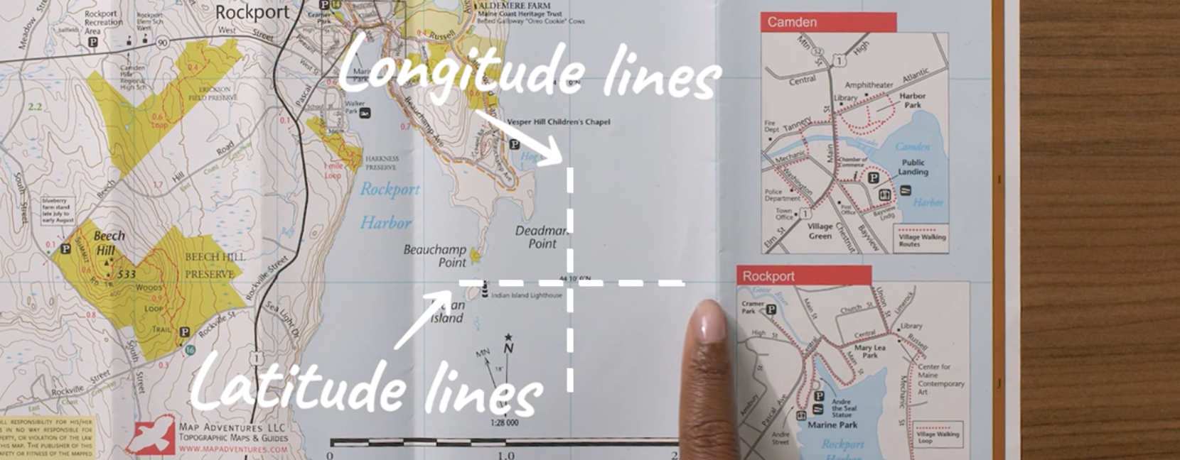 A map with the latitude and longitude lines called out with dotted white lines and arrows.