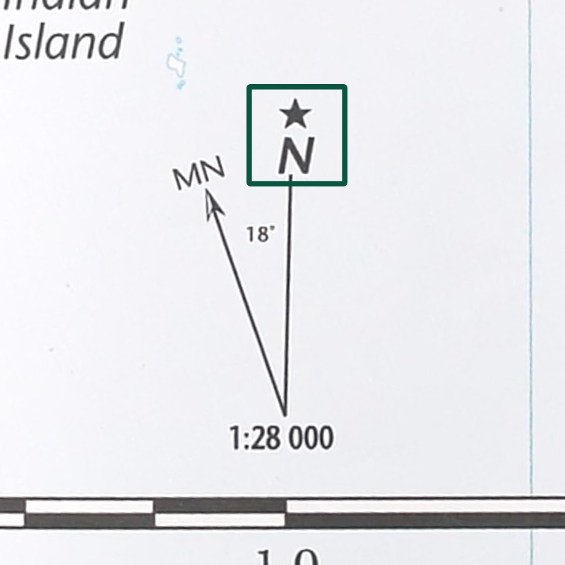 A close-up of a map's declination diagram with a green box around a star and a capital N, referring to true north.