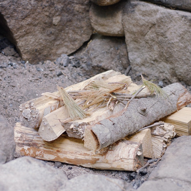 Tinder on top of 2 layers of fuel logs.