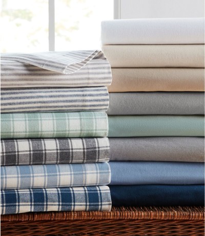 Two stacks of L.L.Bean Flannel Sheets, solid, strips and checkered.