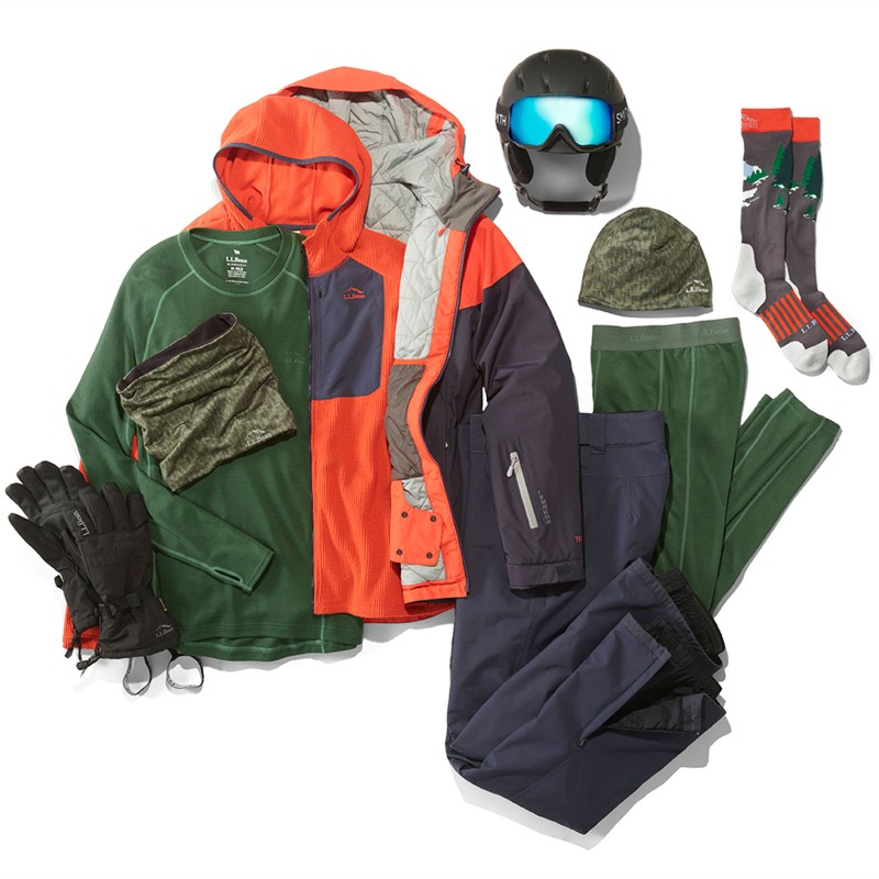 A laydown of clothing needed for alpine skiing.