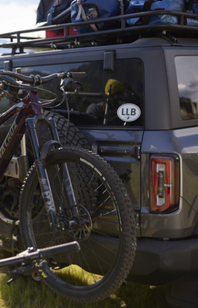 Image of a mountain bike in a car rack on the back of a car
