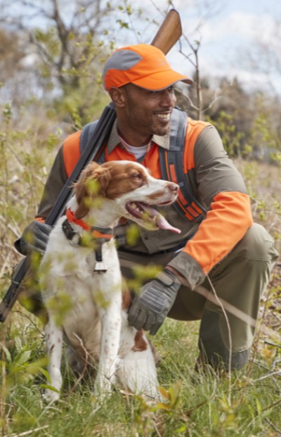 Man with dog hunting in a grassy field